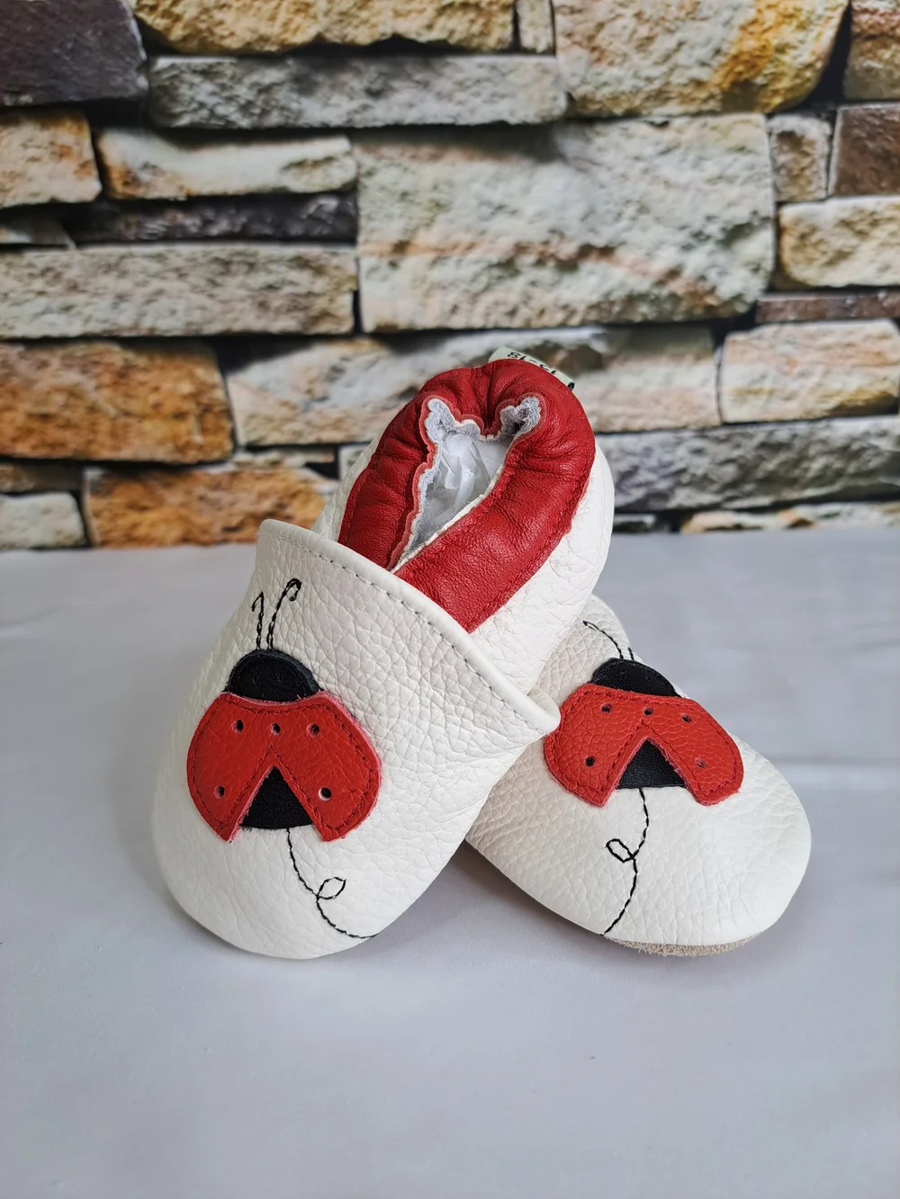 Baby White Leather Slip-On Shoes with Red Ladybug Detail